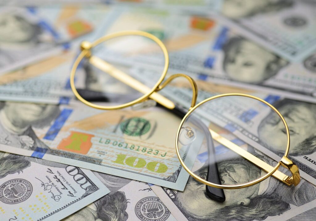 glasses on money