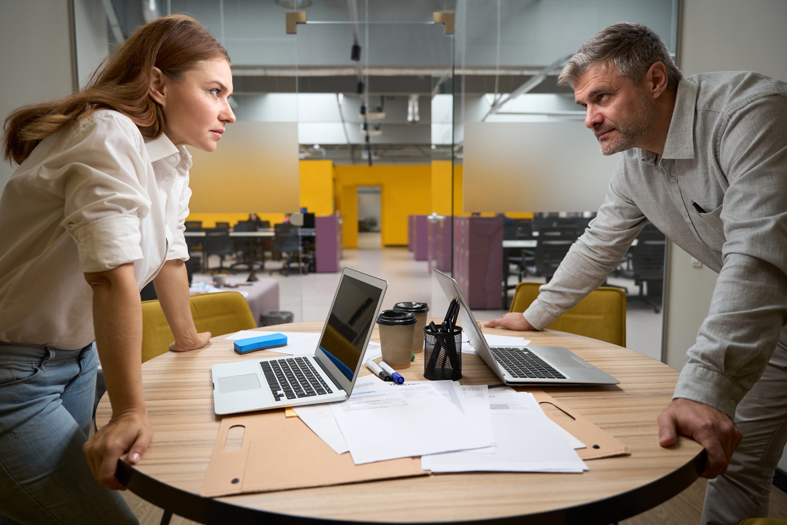 Office workers discussing with each other in coworking Coworkers at odds with each other.