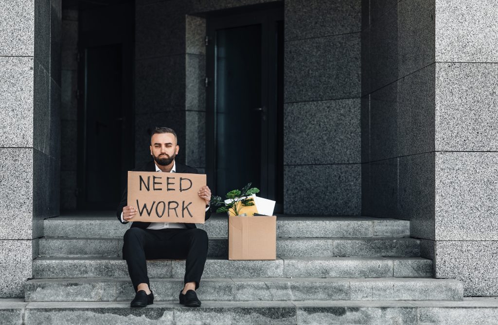 unemployed man sitting on steps