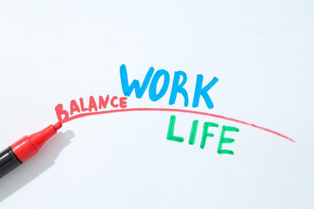 Concept of work-life balance, writing in notebook.