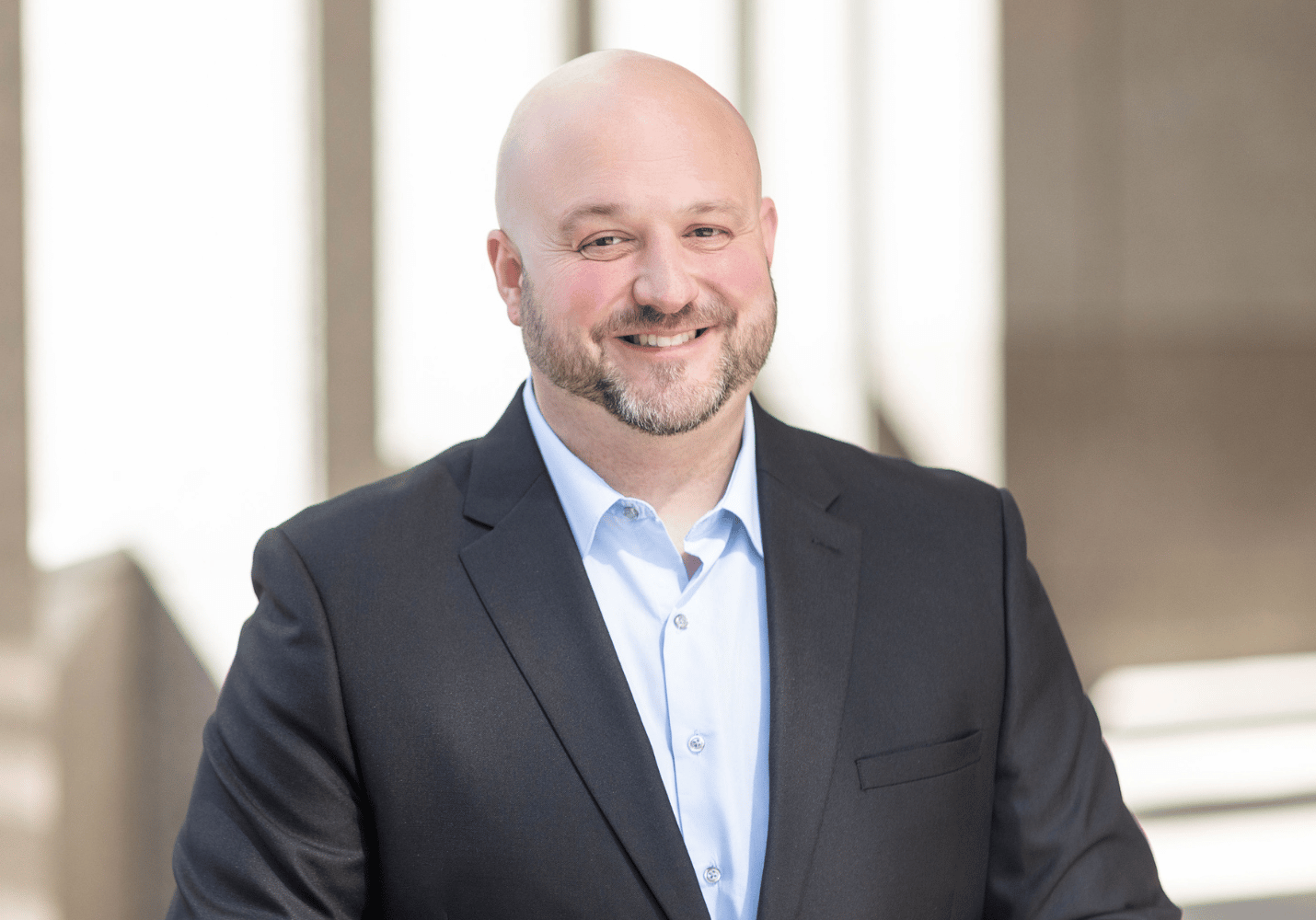 20 Q w Gregor Photo of man wearing a suit and smiling
