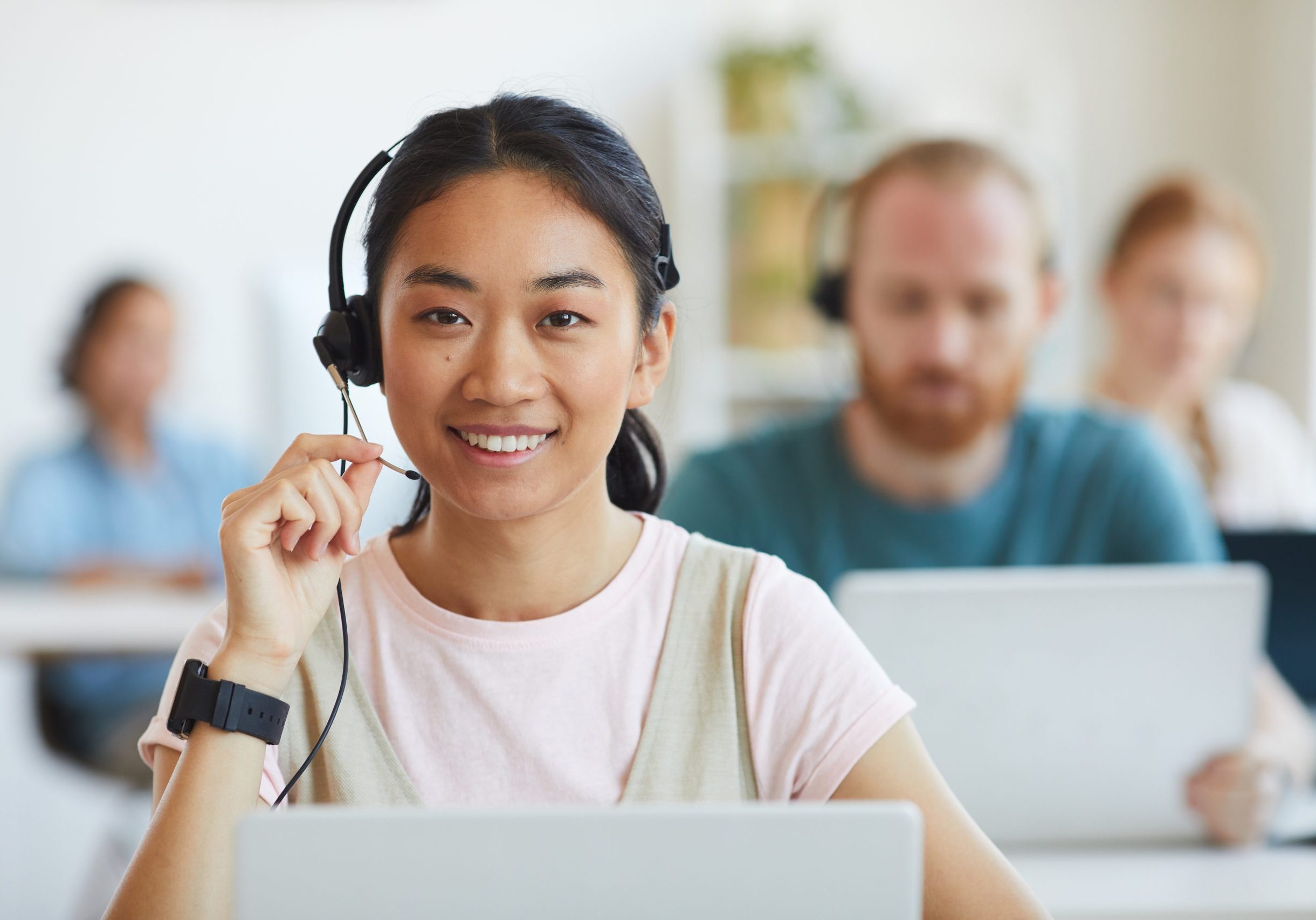 Customer service worker Young woman with headset smiling