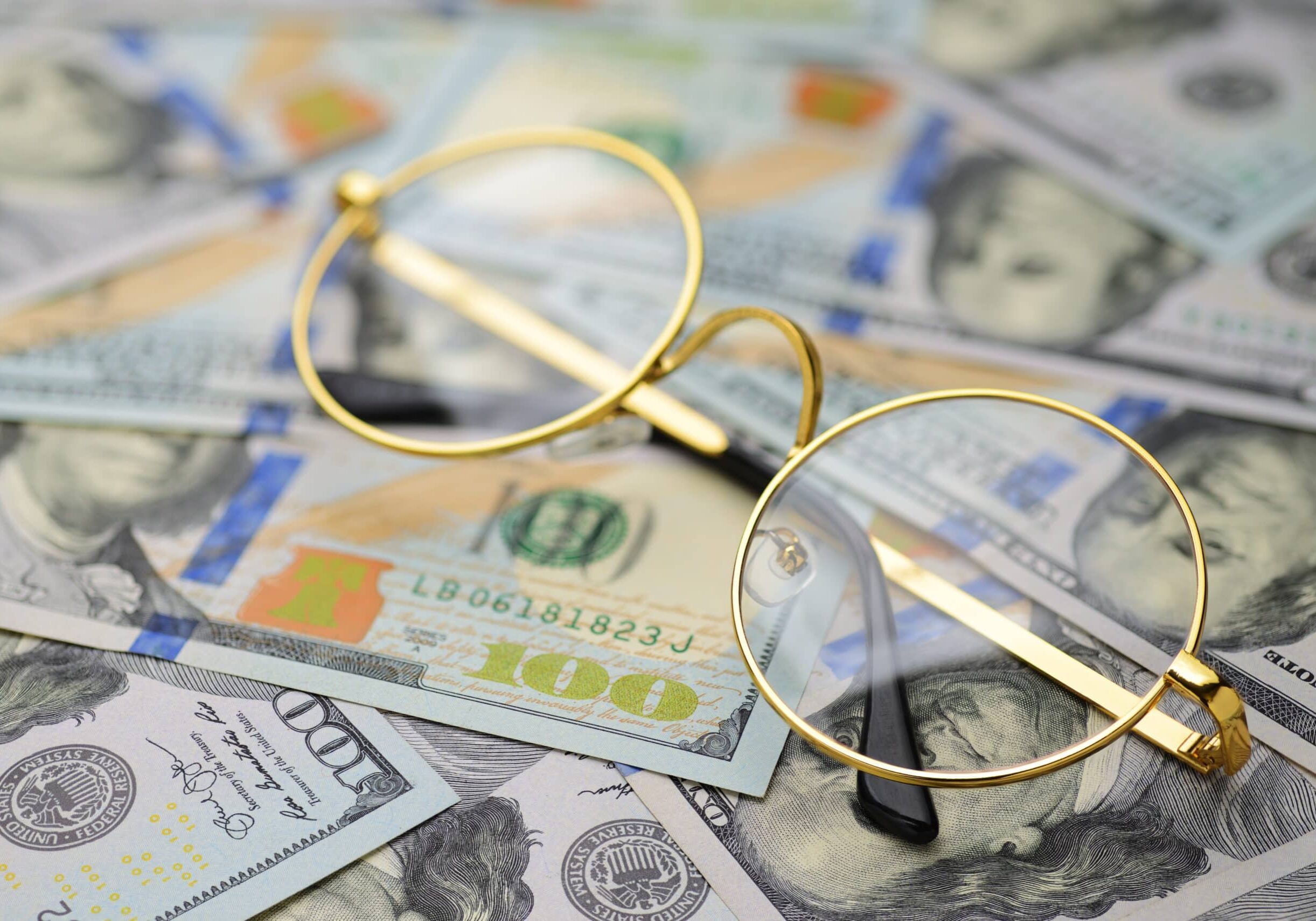 Financial accounting analyst glasses on money