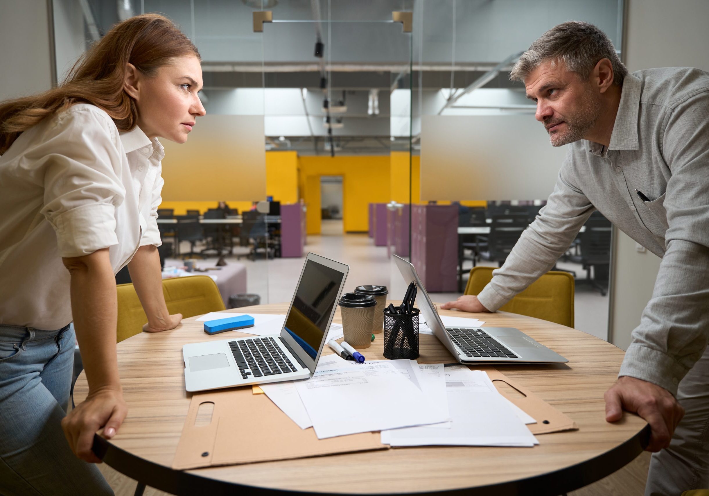 Office workers discussing with each other in coworking Coworkers at odds with each other.