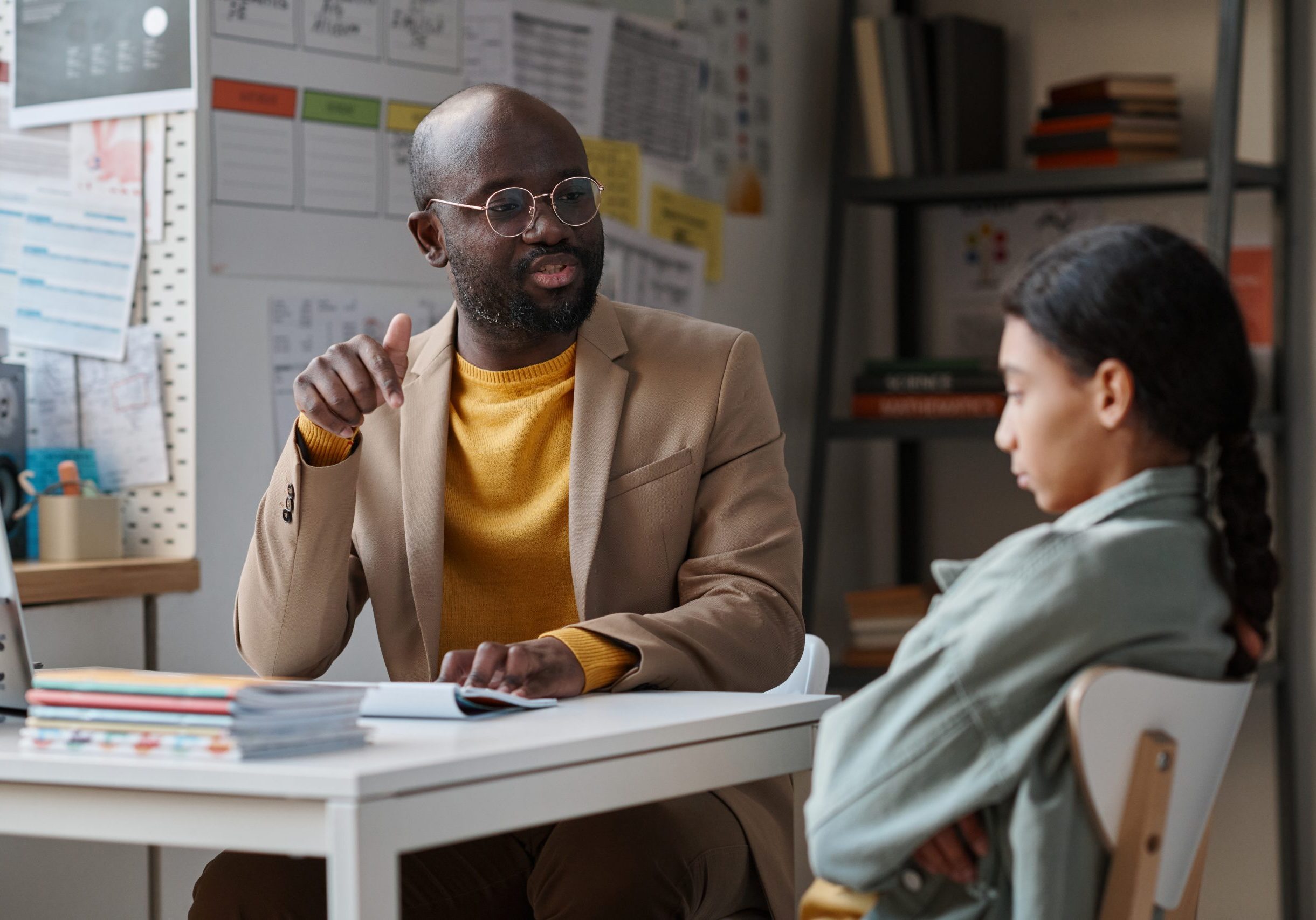 Teacher having a serious conversation with schoolchild Boss talking with young employee